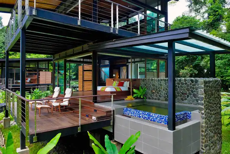 Luxurious room at Borneo Rainforest Lodge featuring an outdoor deck and private plunge pool, offering a complete immersion in the Danum Valley rainforest.