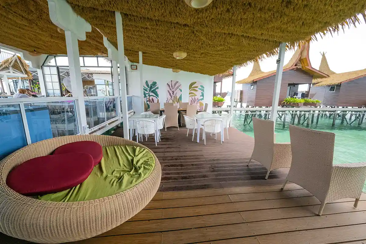 Dine and relax right over the turquoise water. Relaxing open-air lounge and restaurant deck at Dayang Resort, with comfortable seating for enjoying meals and drinks right over the water.