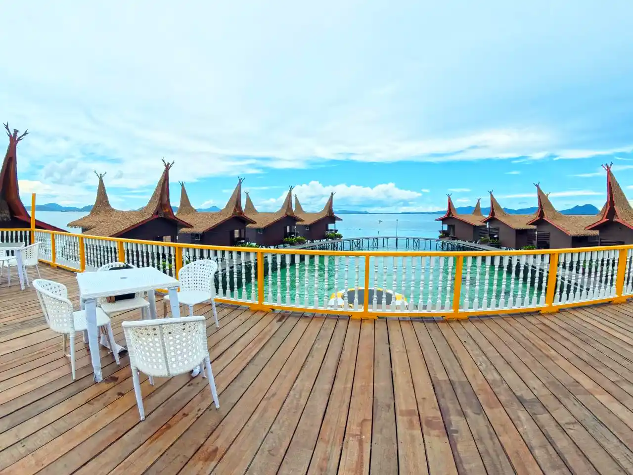 The best spot to enjoy the resort's panoramic view. Main viewing terrace at Dayang Resort, with tables and chairs set up for guests to enjoy the panoramic view of the overwater hideaway.